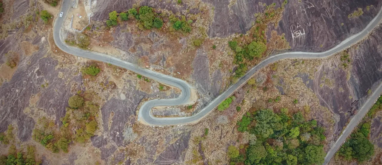 Aerial view of a winding mountain road across exposed rock