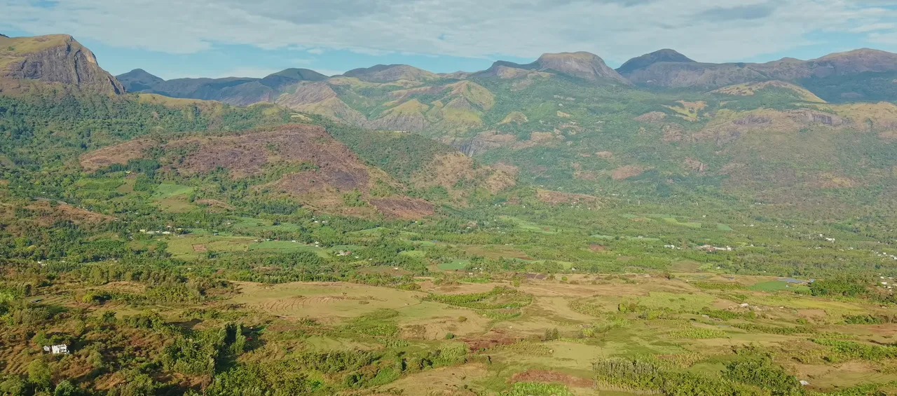 Wide panorama of the Kanthalloor valley and surrounding peaks