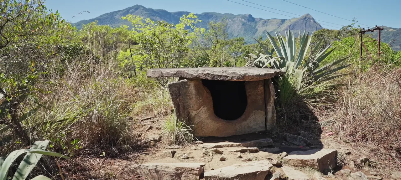 Ancient stone dolmen with the Marayoor mountains behind it